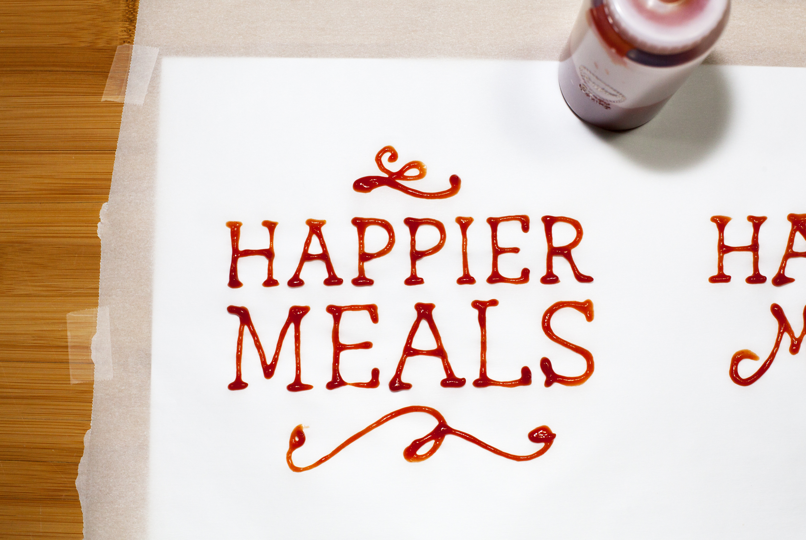 Happier Meals title hand-lettered with ketchup production image