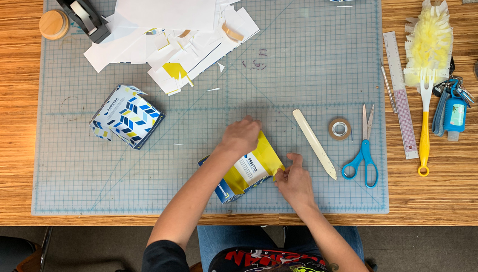 Process photo of McKenzie building the Proctor Loan Protector branded box